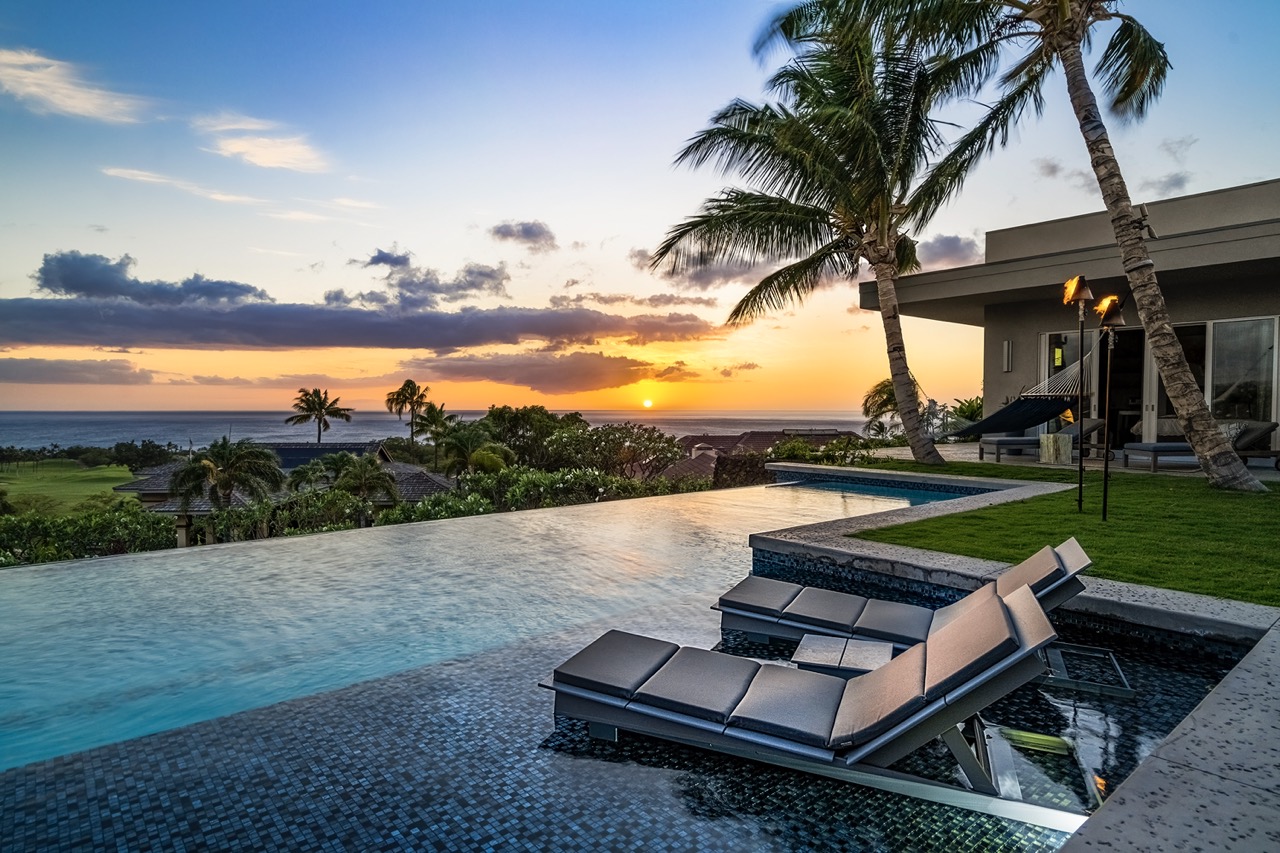 Pool lounge at sunset — fire bowl, wine and ocean views