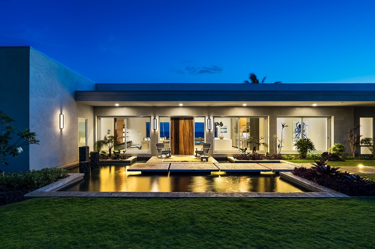 Hapuna Modern House — still-pond entrance at twilight