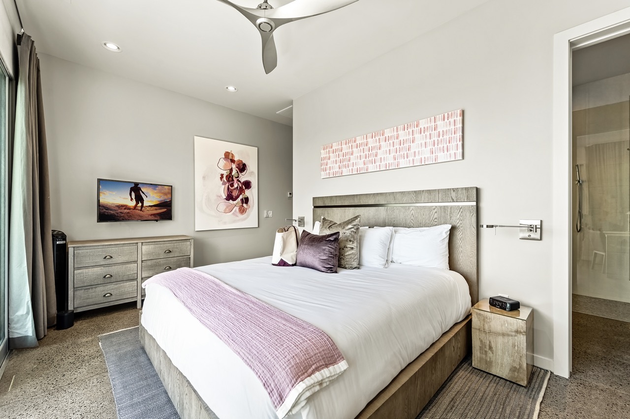 Fleur Suite — king bedroom with coral artwork and private lanai