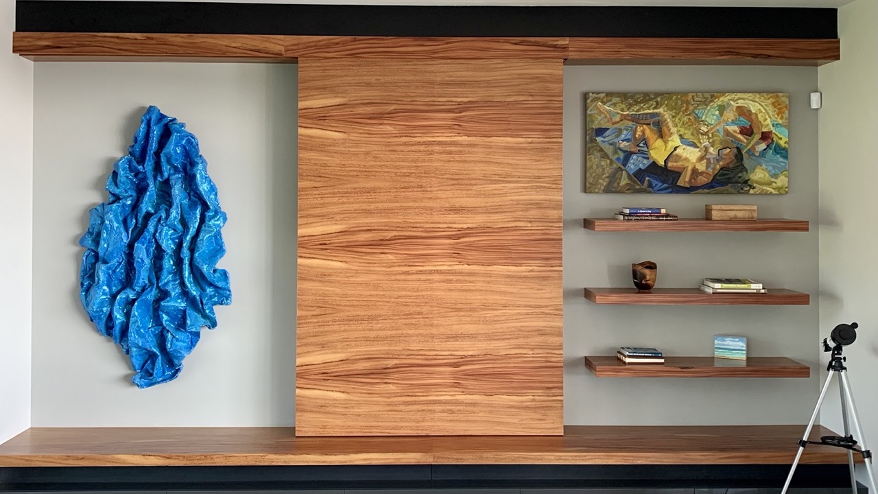 Great room art wall — monkeypod wood and curated Hawaiian art