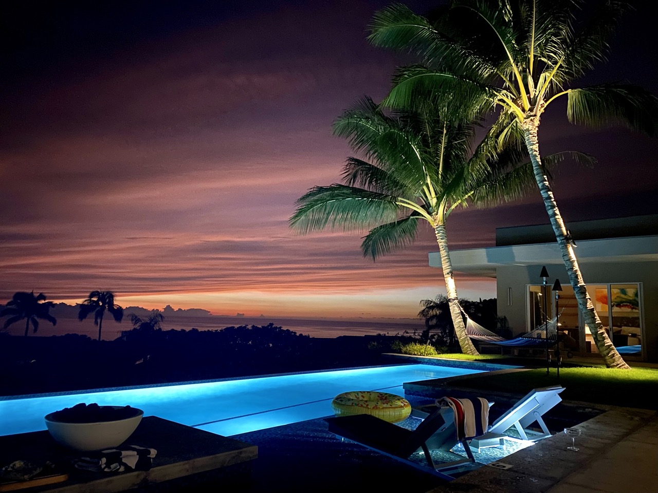 Pool at night, glowing blue under stars